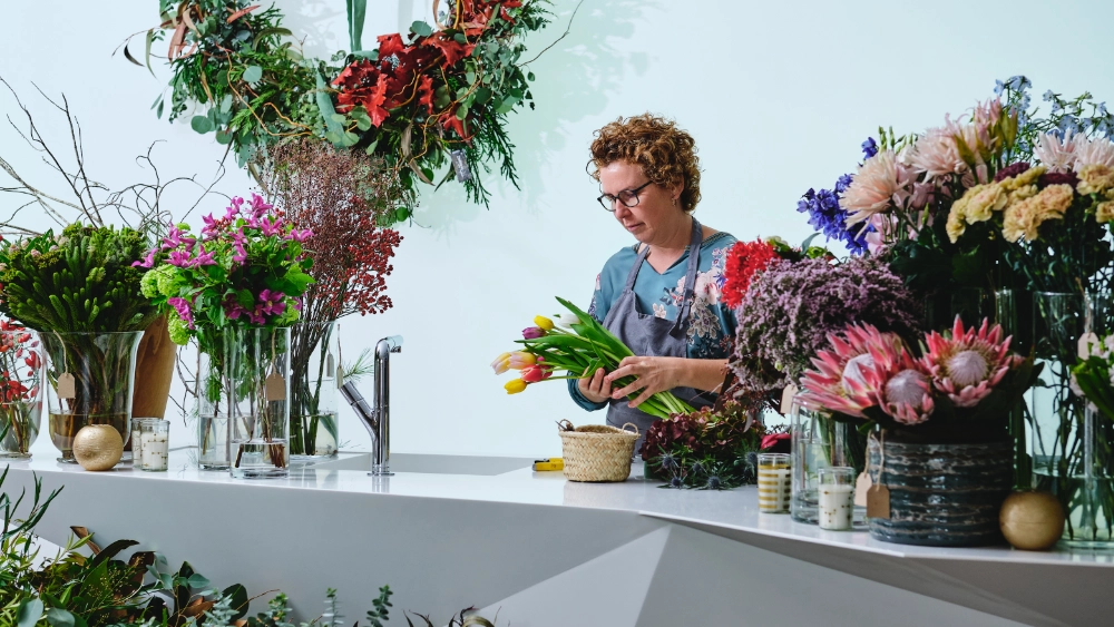 Florist arranging an assymetrical flower arrangement