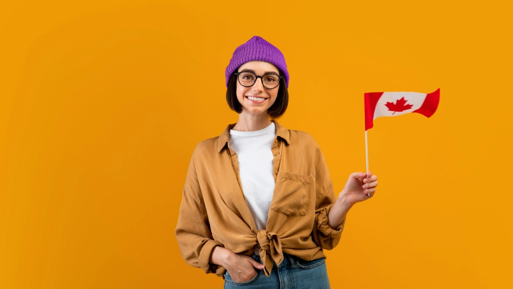 a tourist woman waving a small flag of Canada